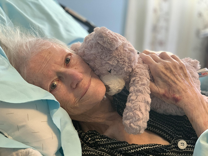 grandmother hugging teddy bear