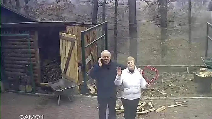 old people being wholesome grandparents waving at security camera