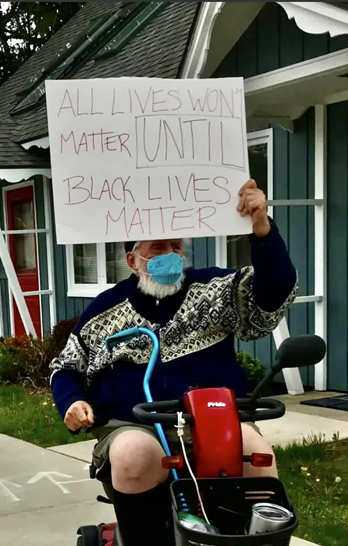 old people being wholesome man protesting in scooter