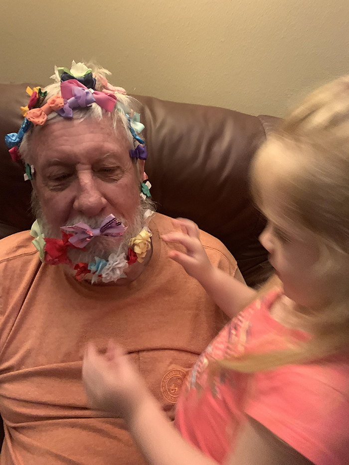 old people being wholesome retired air force colonel playing with granddaughter