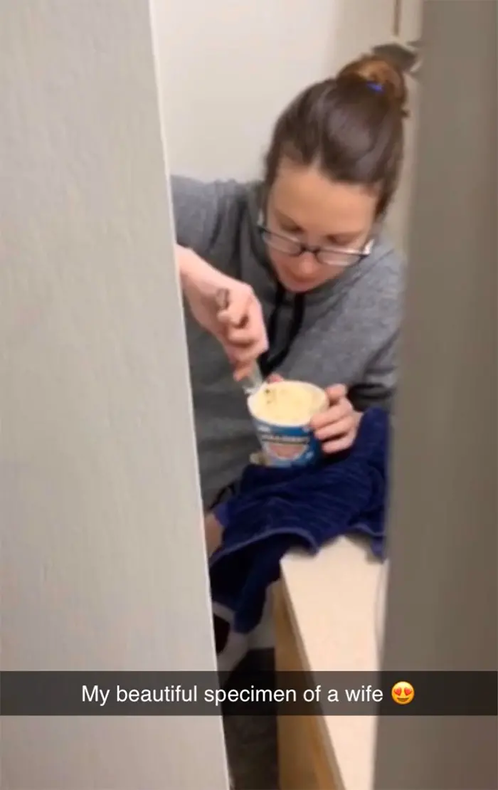 pregnant women struggles eating ice cream in the bathroom