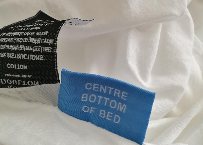 bed sheet tag showing which side you are holding
