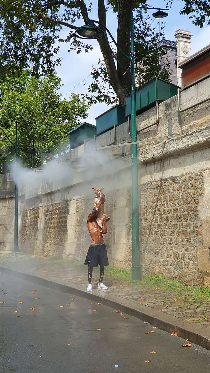 guy helping dog cool off hot day