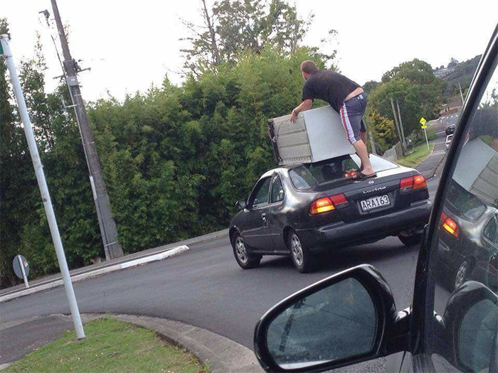 strange things holding fridge on top car