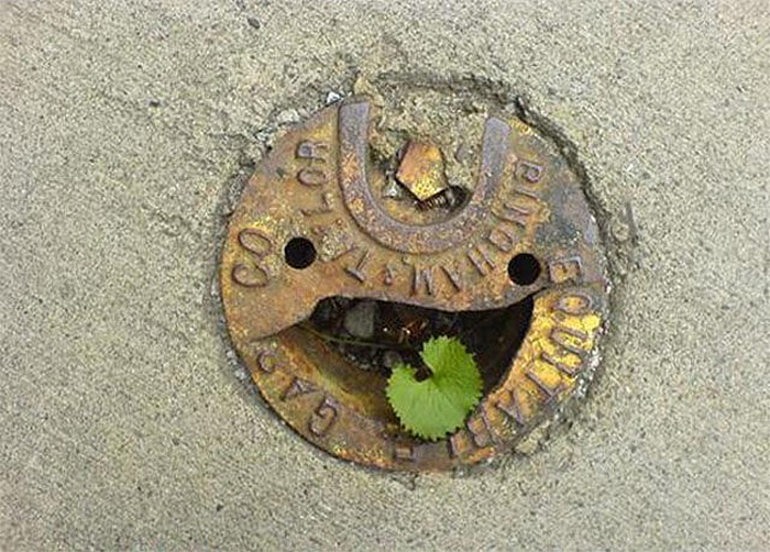 faces everywhere happy manhole cover