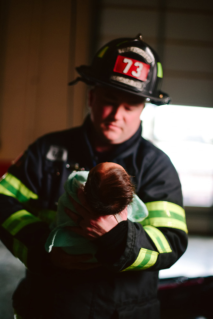 fireman carrying a newborn