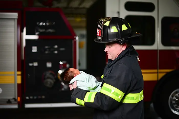 fireman looking after a newborn