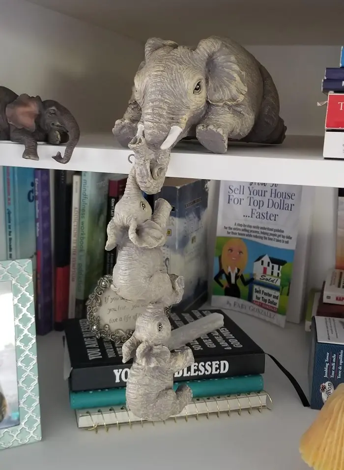 mother elephant with dangling baby elephants bookend statue